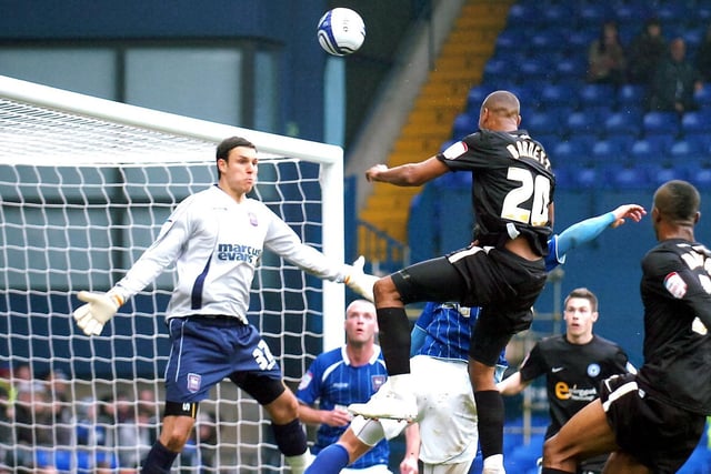 "Tyrone Barnett leaps high for a header against Ipswich Town at Portman Road."