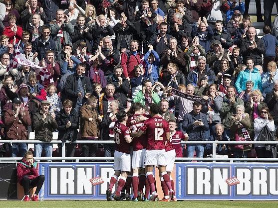 The Cobblers players mob goalscorer Zander Diamond after he netted the opener on four minutes