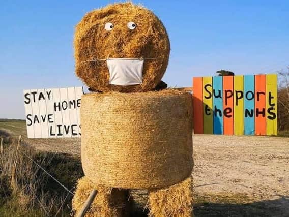 Charlotte Heath and her sister made this straw bale man to cheer up people who walk or cycle past him on the South Downs