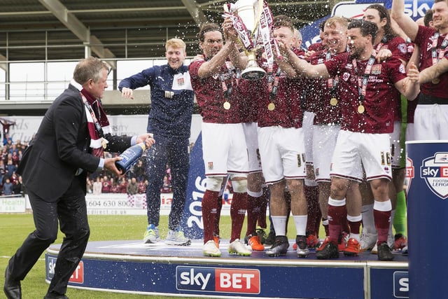Boss Chris Wilder gets the party started with the first spray of Champagne