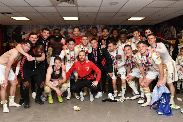 Dons celebrating promotion in the dressing room