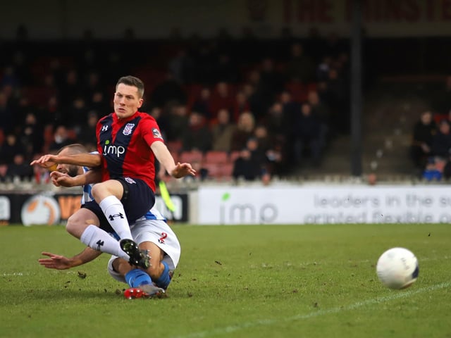 Tackle! Gary Stohrer timed his challenge on the ball to perfection. Studs and turf everywhere this shot summed up what was an excellent performance by Kettering away at title favourites York City, even though it ended in a narrow 1-0 loss.
