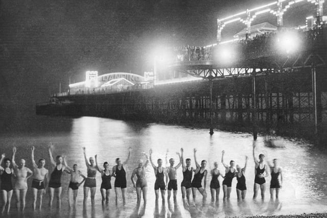 By the early 1930s Hastings Pier featured a variety of illuminations, which led to the rise in popularity of night-time swimming. Picture courtesy of Hastings Library