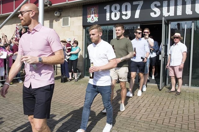 Jasaon Taylor leads the way as the Cobblers players get ready for the parade