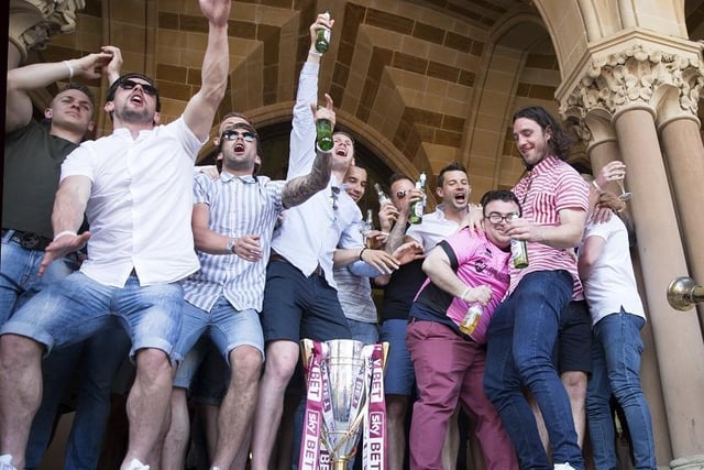 The players carry on the party on the steps of the Guldhall