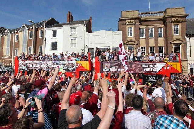 Fans welcome the buses on to the Market Square
