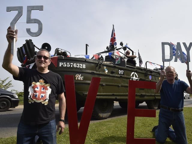 Mark Sidaway and Joseph Dobson celebrating alongside the WW2 DUKW EMN-200805-180457009