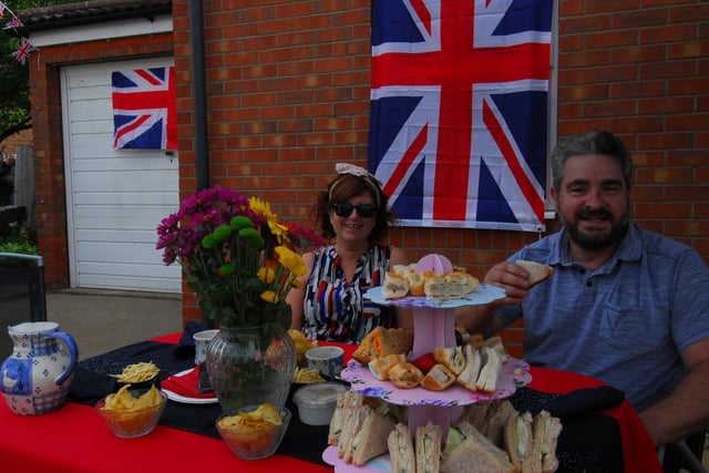 Karen and Russell Dodds of Curlew Way, Sleaford enjoying a front garden party with cakes, flags and bunting.