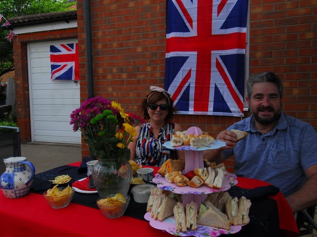 Karen and Russell Dodds of Curlew Way, Sleaford enjoying a front garden party with cakes, flags and bunting.