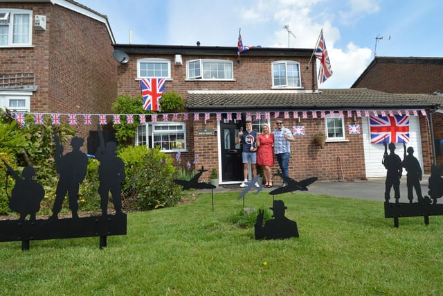 Harrison Fowler, Clare Fowler and Duane Fowler celebrate VE Day in their garden on Dover Street, Kibworth.