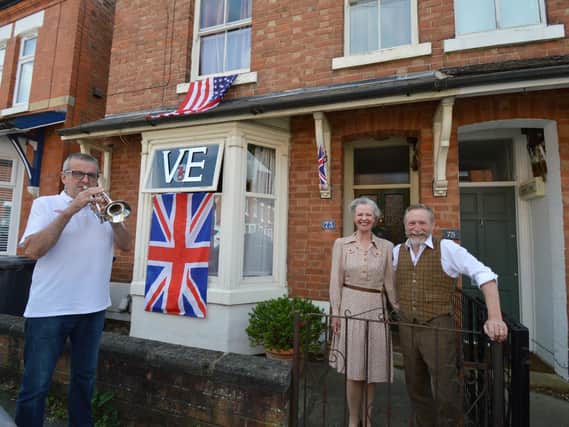 John Pacey plays the last post in Market Harborough with neighbours Helen and Dave Allen on Nelson Street.
