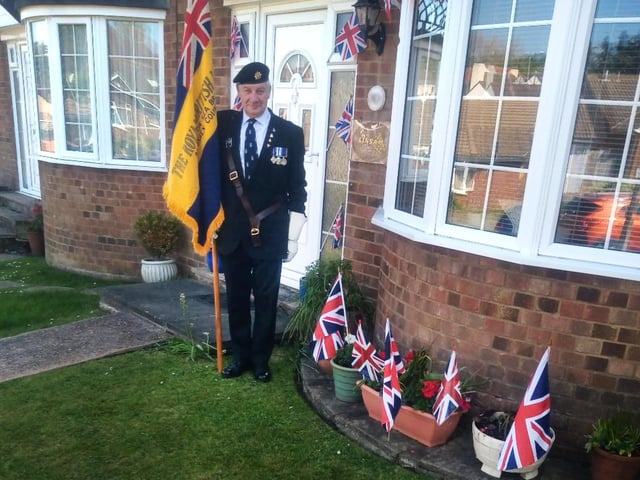 Hastings area Ve Day 5
Bexhill Royal British Legion standard bearer Sam Fisher doing a salute at 3pm on VE Day 2020 during the UK's lockdown.
Photo by Linda Fisher. SUS-201105-093827001