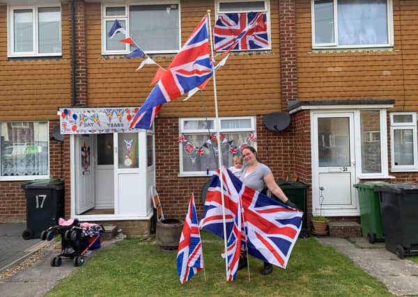 Socially distanced VE Day celebrations in Winkney Road, Hampden Park, organised by Gemma Collumbell. Gemma is pictured here outside  her home with her daughter. SUS-201105-101942001
