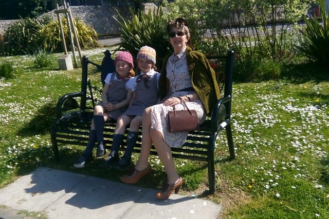 Gina Penn with twins Sasha and Scarlet on the memorial bench in Church Street, Littlehampton