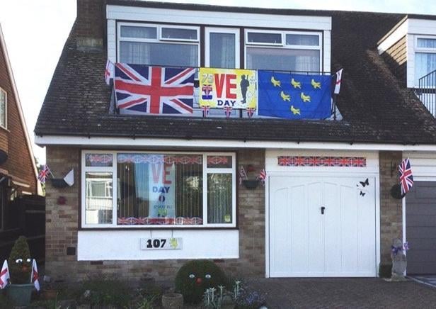 Roger Blackwell, in Greenleaf Gardens, Polegate, decorated the front of his house for VE DAy. SUS-201105-114447001