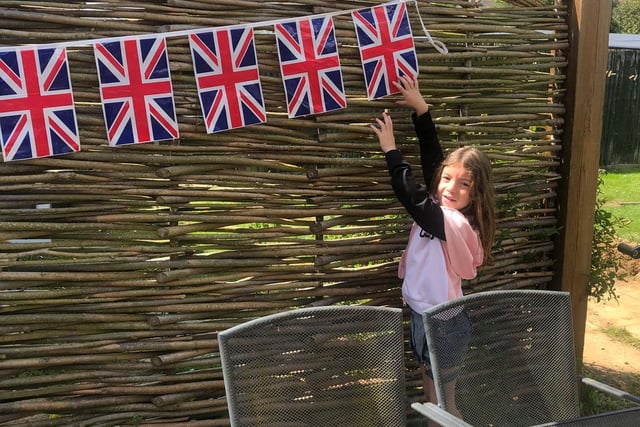 Daisy Wagstaff puts up Union Jack flags at her Banbury home