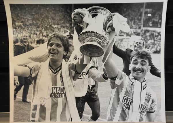 Micky Gynn (right) lifts the FA Cup at Wembley.