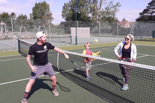 Lewis, Maisie and Arlo Minett in action at Fishbourne Tennis Club