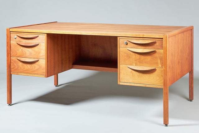 An American desk in walnut designed by Jens Risom, circa 1960 with three drawers to either side of the knee hole, finished back, maker's label. POA from Augustus Brandt