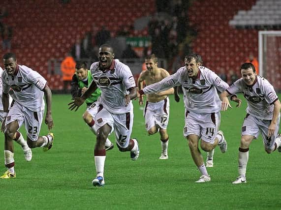 The Cobblers players celebrate the club's famous penalty shootout win at Anfield