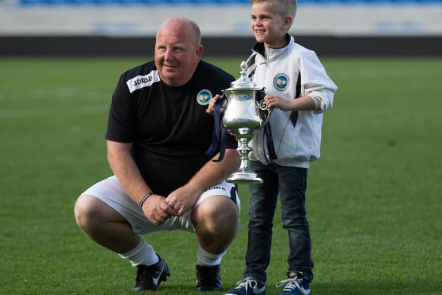 Tony Coade and a young fan with the trophy