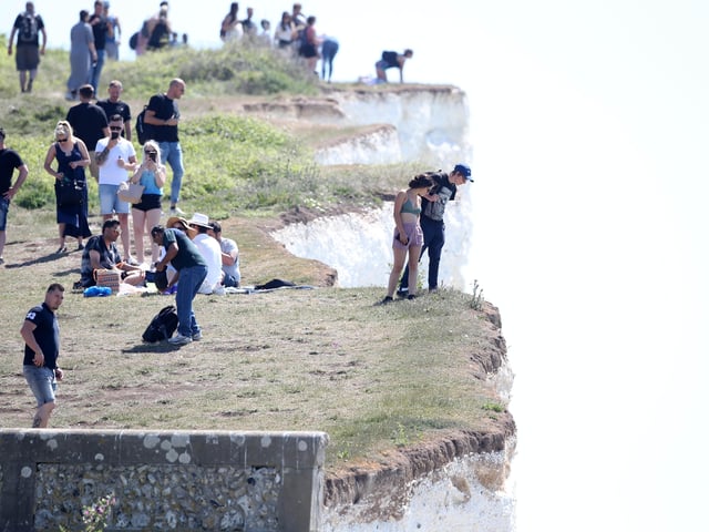 Large numbers of visitors were pictured at Birling Gap on Monday