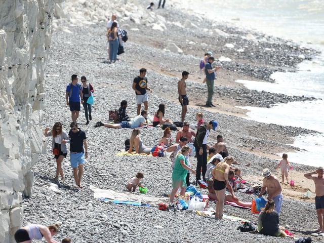 Large numbers of visitors were pictured at Birling Gap on Monday