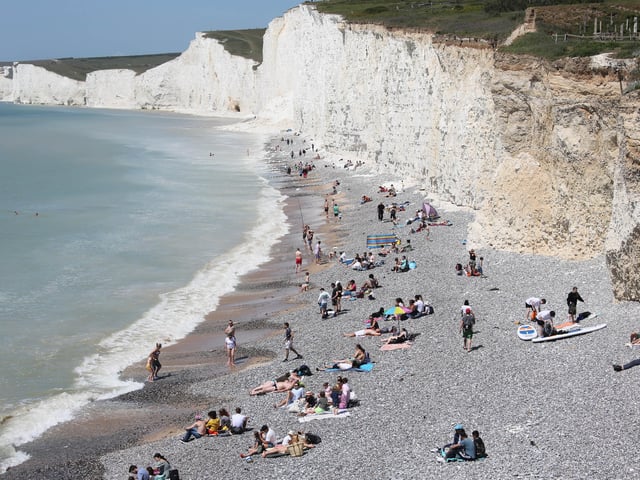 Large numbers of visitors were pictured at Birling Gap on Monday