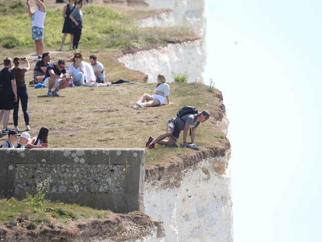 Large numbers of visitors were pictured at Birling Gap on Monday
