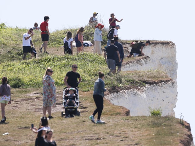 Large numbers of visitors were pictured at Birling Gap on Monday