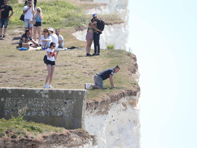 Large numbers of visitors were pictured at Birling Gap on Monday