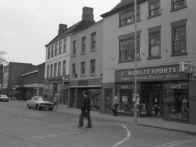J. Morley Sports Ltd can be seen advertising its range of goods – ‘sports, fishing tackle, guns’. Today, it is the former Clintons unit. Addys can be seen behind it in the current home of Specsavers.