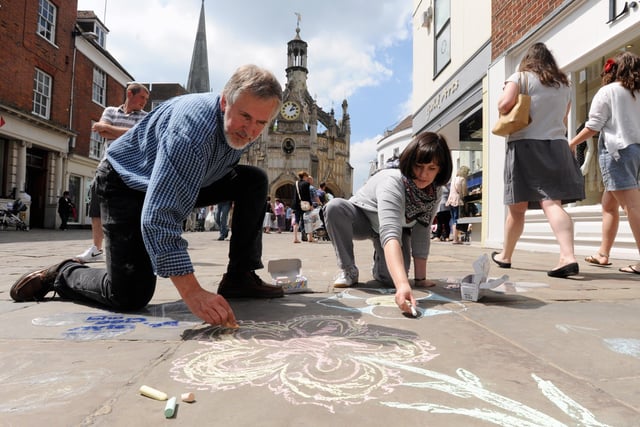 Drawing a path of flowers on the pavement to mark the 2010 Festival of Flowers