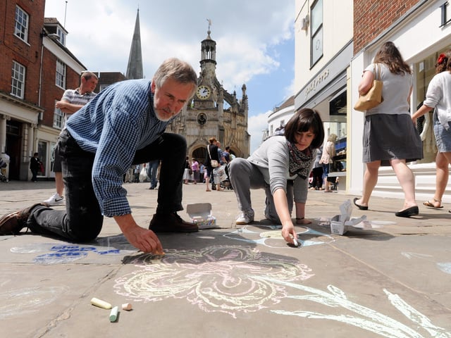 Drawing a path of flowers on the pavement to mark the 2010 Festival of Flowers