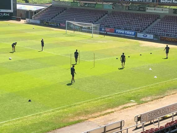 Cobblers players step foot onto the PTS pitch for the first time in over 10 weeks. Pictures: Northampton Town FC.