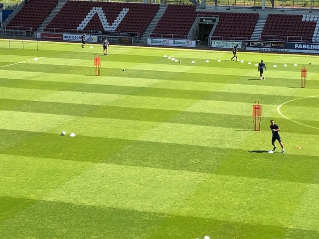 Cobblers players keep their distance.