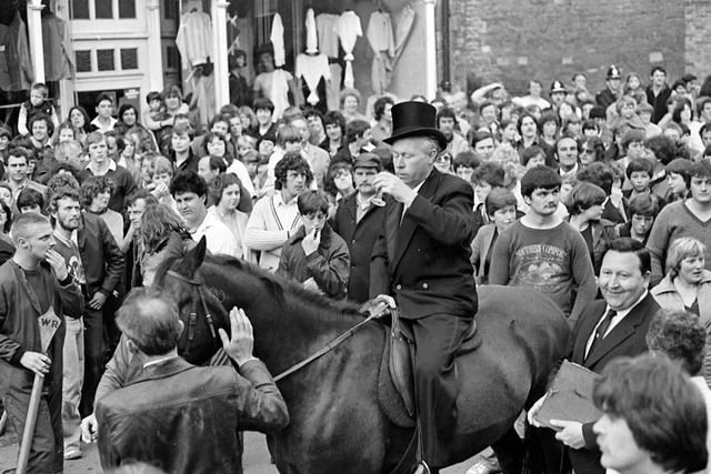 Hundreds watch on as the bailiff rides through Rothwell.