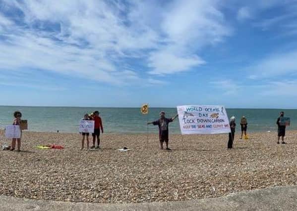 Members of Extinction Rebellion Lewes gather on Seaford beach to celebrate World Oceans Day