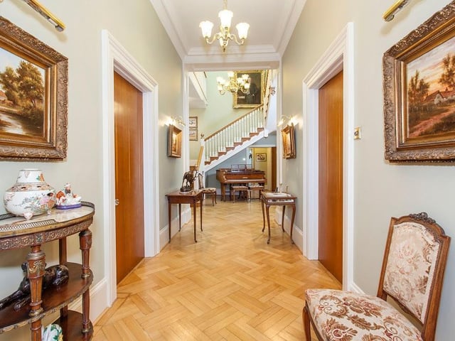 The hallway opens up to reveal a double height galleried landing with four stained glass windows in the roof.