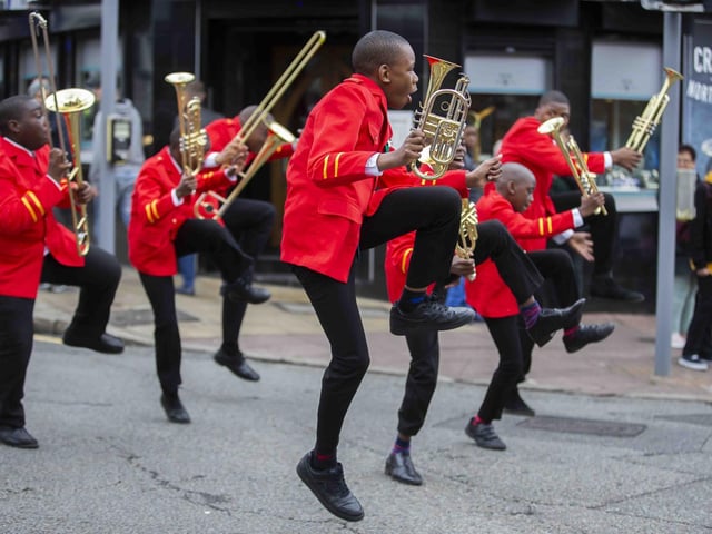 A brass band entertaining carnival-goers.