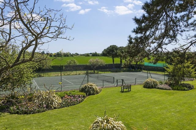 Features a hard tennis court and heated swimming pool.