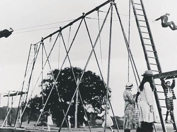 Young daredevils see how high they can go on the swings, thought to be the first swings in the UK.