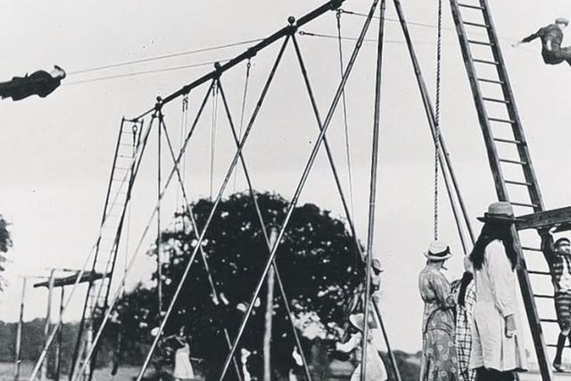 Young daredevils see how high they can go on the swings, thought to be the first swings in the UK.