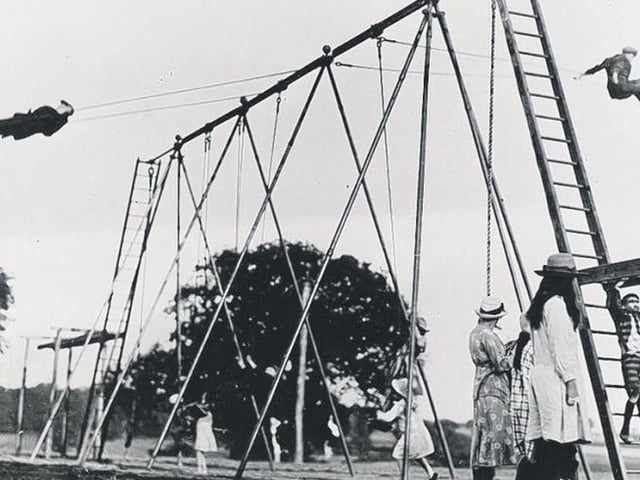 Young daredevils see how high they can go on the swings, thought to be the first swings in the UK.