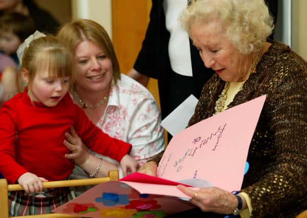 Dame Vera Lynn's 90th birthday at The School for Parents in Five Oaks. Receiving a card from Ella - Marie Bird, 4, with her mother Donna. Picture: Derek Martin Photography