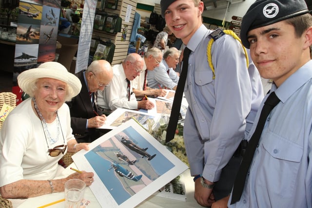 Dame Vera Lynn signs prints for Air Cadets, Fl Sgt Ben Clarke left and Cpl Mike Jenning. Photo by Derek Martin Photography