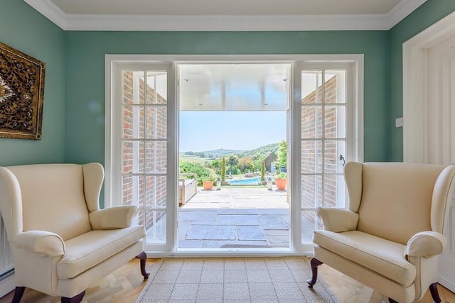 The front door leads into the hall from which the eye is instantly drawn out to the garden and the beautiful far reaching Downland views beyond.