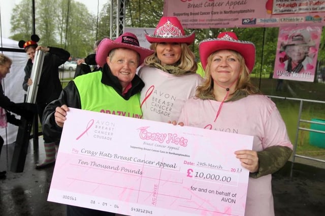 Crazy Hats has raised a huge amount of money to support breast cancer care. Here is Glennis Hooper (left) at Wicksteed Park with a cheque for 10,000 in 2013. (Photo by Alison Bagley)