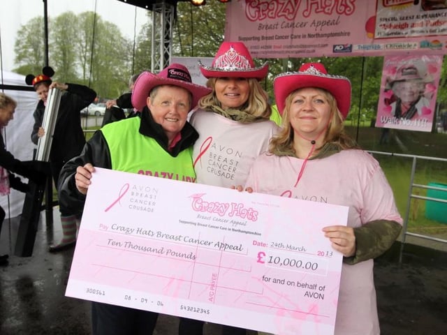 Crazy Hats has raised a huge amount of money to support breast cancer care. Here is Glennis Hooper (left) at Wicksteed Park with a cheque for 10,000 in 2013. (Photo by Alison Bagley)