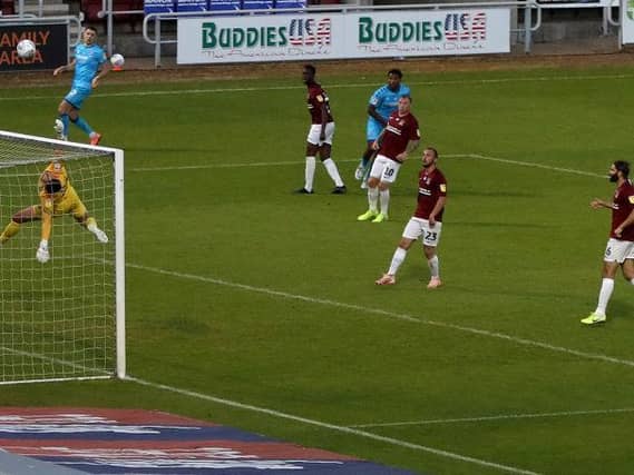 Steve Arnold tips over Reuben Reid's effort.